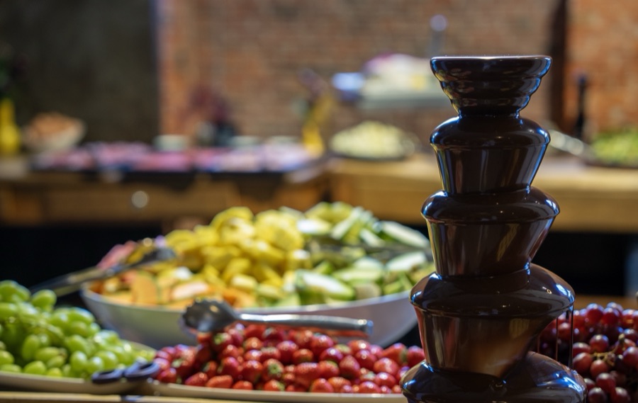The chocolate fountain and fresh fruit on the buffet.